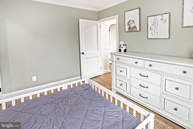 5000 Ogletown Stanton Rd, Newark, DE 19713 - bedroom featuring ornamental molding, light wood-style flooring, and arched walkways
