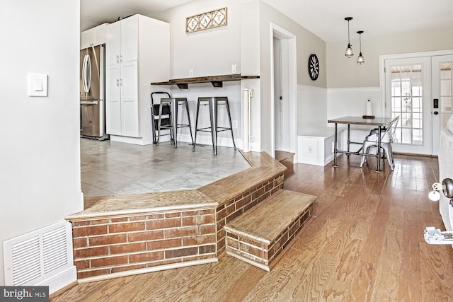 5000 Ogletown Stanton Rd, Newark, DE 19713 - living room featuring wainscoting and wood finished floors