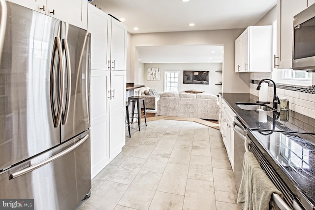 5000 Ogletown Stanton Rd, Newark, DE 19713 - kitchen featuring appliances with stainless steel finishes, a sink, recessed lighting, open floor plan, and white cabinets