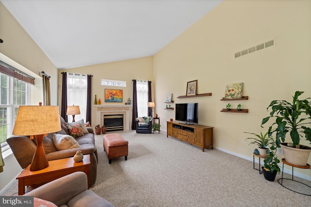 42 Manassas Dr, Middletown, DE 19709 - living room featuring high vaulted ceiling, baseboards, carpet floors, and a glass covered fireplace