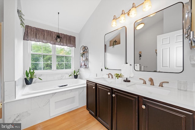 42 Manassas Dr, Middletown, DE 19709 - full bath featuring lofted ceiling, double vanity, a bath, and wood finished floors