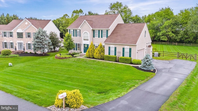 42 Manassas Dr, Middletown, DE 19709 - colonial home with asphalt driveway, a garage, and cooling unit