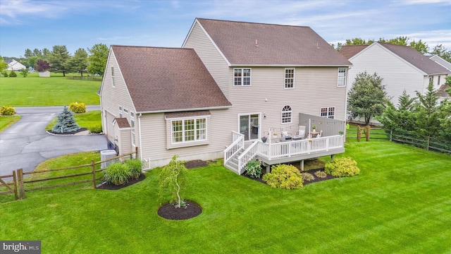 42 Manassas Dr, Middletown, DE 19709 - back of house featuring a wooden deck, roof with shingles, and asphalt driveway