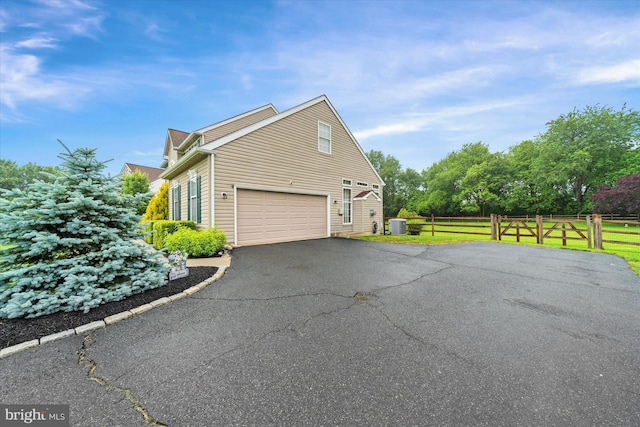 42 Manassas Dr, Middletown, DE 19709 - view of home's exterior with cooling unit, driveway, and a garage