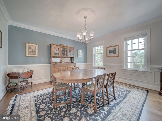 4387 Stepney Dr, Gainesville, VA 20155 - dining space featuring a chandelier, a wainscoted wall, crown molding, and wood finished floors