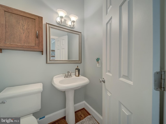 4387 Stepney Dr, Gainesville, VA 20155 - half bath featuring baseboards, toilet, wood finished floors, and a sink