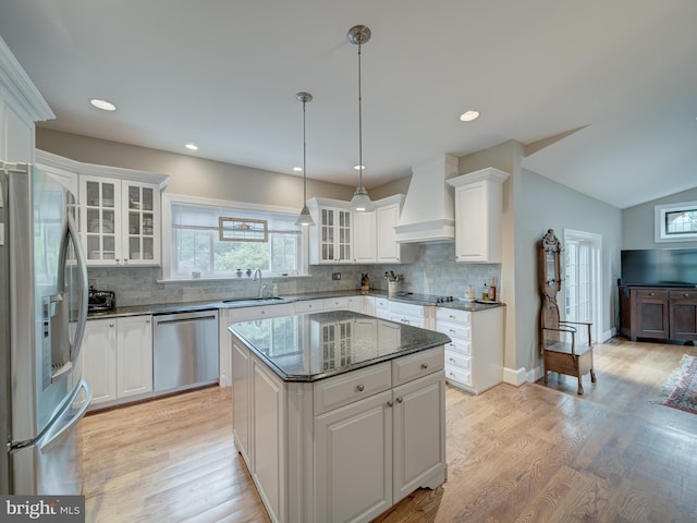 4387 Stepney Dr, Gainesville, VA 20155 - kitchen with stainless steel appliances, custom exhaust hood, a sink, white cabinetry, and decorative backsplash