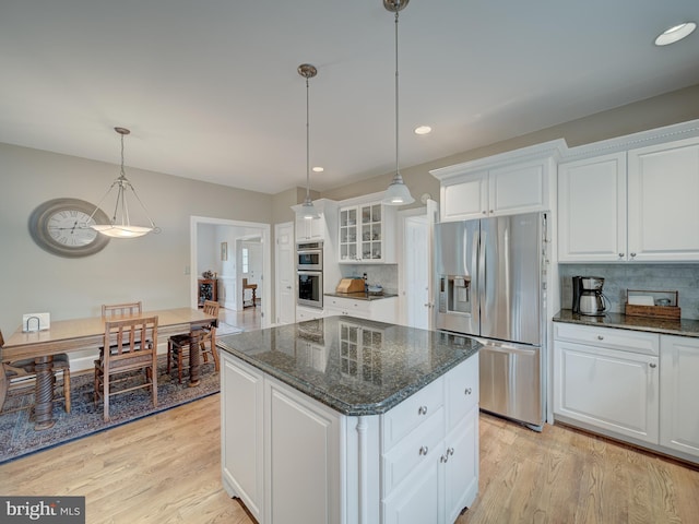 4387 Stepney Dr, Gainesville, VA 20155 - kitchen with appliances with stainless steel finishes, white cabinetry, light wood-style flooring, a kitchen island, and recessed lighting