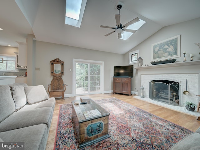 4387 Stepney Dr, Gainesville, VA 20155 - living room with a skylight, a ceiling fan, light wood-style floors, and vaulted ceiling
