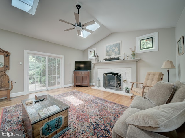 4387 Stepney Dr, Gainesville, VA 20155 - living area with a skylight, plenty of natural light, ceiling fan, wood finished floors, and vaulted ceiling