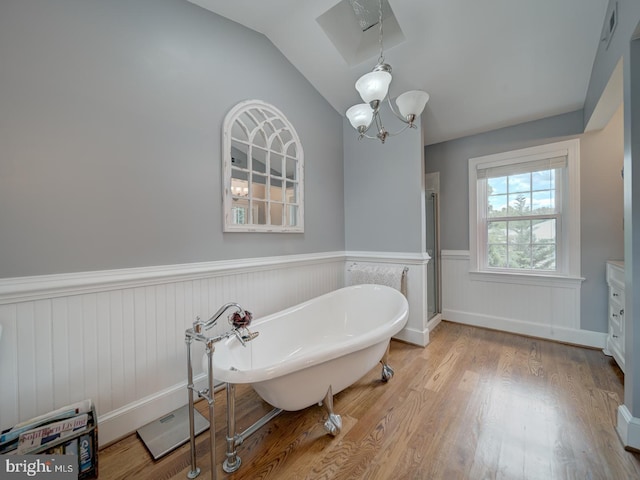 4387 Stepney Dr, Gainesville, VA 20155 - bathroom featuring a wainscoted wall, a chandelier, wood finished floors, a freestanding bath, and a stall shower