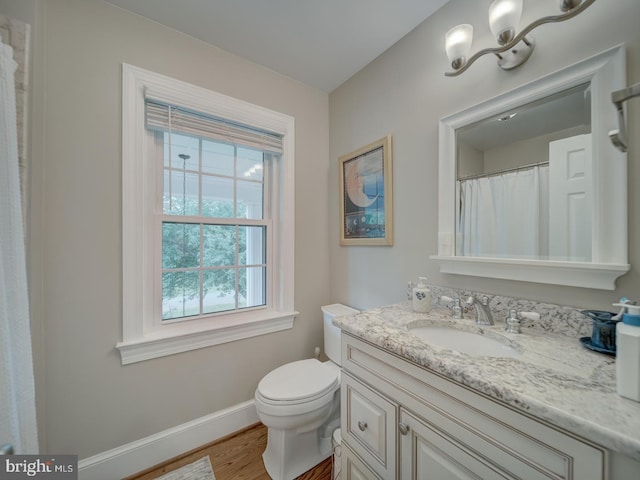 4387 Stepney Dr, Gainesville, VA 20155 - bathroom with vanity, wood finished floors, toilet, and baseboards