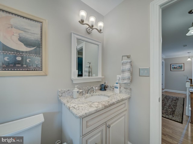 4387 Stepney Dr, Gainesville, VA 20155 - bathroom featuring toilet, vanity, wood finished floors, baseboards, and ornamental molding