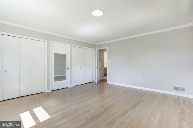11830 Charles Rd, Silver Spring, MD 20906 - unfurnished bedroom featuring two closets, light wood-type flooring, ornamental molding, and baseboards