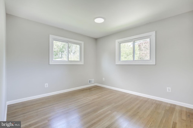 11830 Charles Rd, Silver Spring, MD 20906 - spare room with plenty of natural light, wood finished floors, and baseboards