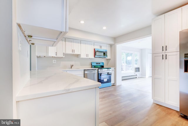 11830 Charles Rd, Silver Spring, MD 20906 - kitchen featuring stainless steel appliances, white cabinets, light wood-type flooring, light stone countertops, and recessed lighting