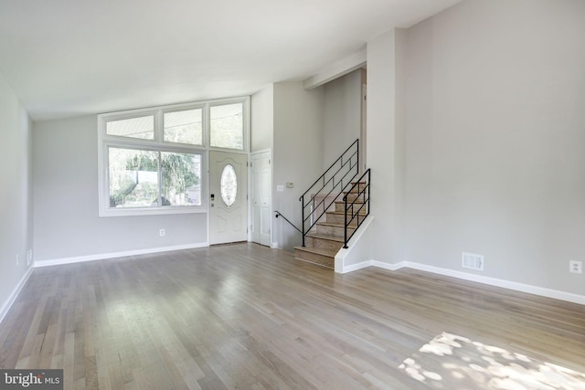 11830 Charles Rd, Silver Spring, MD 20906 - unfurnished living room featuring wood finished floors, stairs, and baseboards