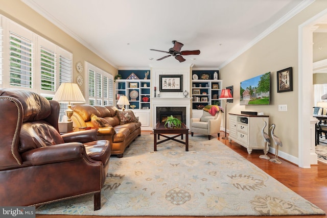 70 Battery Point Dr, Fredericksburg, VA 22406 - living area with a ceiling fan, wood finished floors, crown molding, a large fireplace, and built in features