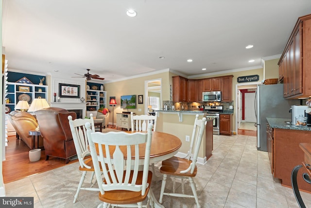 70 Battery Point Dr, Fredericksburg, VA 22406 - dining room featuring a ceiling fan, recessed lighting, ornamental molding, light tile patterned floors, and a fireplace