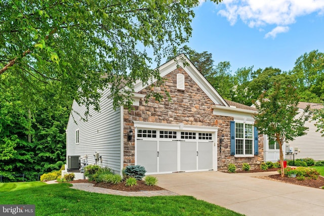 70 Battery Point Dr, Fredericksburg, VA 22406 - view of front of property with stone siding, driveway, central AC, and a garage