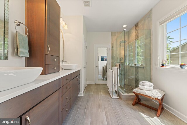 70 Battery Point Dr, Fredericksburg, VA 22406 - bathroom with baseboards, a shower stall, double vanity, and wood finished floors