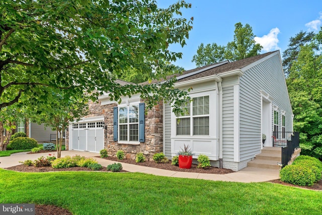70 Battery Point Dr, Fredericksburg, VA 22406 - view of front of home with concrete driveway, an attached garage, a front lawn, roof with shingles, and stone siding