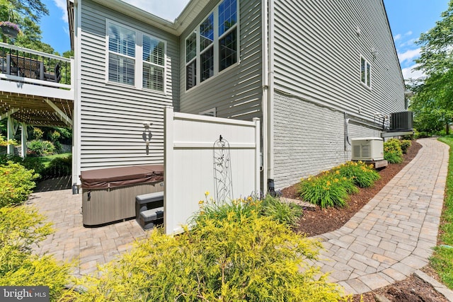 70 Battery Point Dr, Fredericksburg, VA 22406 - view of side of home with a hot tub, a patio area, and central AC unit