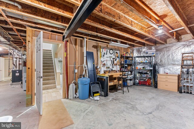70 Battery Point Dr, Fredericksburg, VA 22406 - unfinished basement featuring stairs, heating unit, and a workshop area