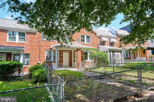 66 Allison St NE, Washington, DC 20011 - view of front of home featuring brick siding and a fenced front yard