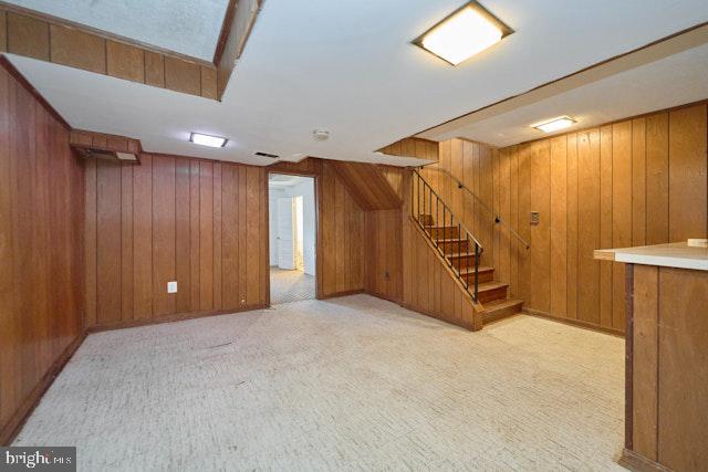 66 Allison St NE, Washington, DC 20011 - finished below grade area with wood walls, stairs, and light carpet