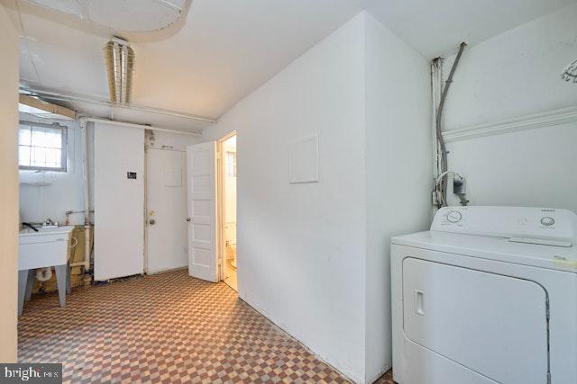 66 Allison St NE, Washington, DC 20011 - laundry room with washer / clothes dryer and tile patterned floors