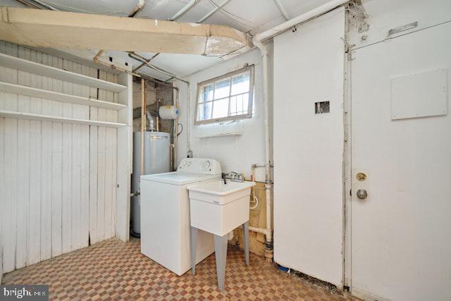 66 Allison St NE, Washington, DC 20011 - washroom featuring washer / dryer, water heater, and tile patterned floors