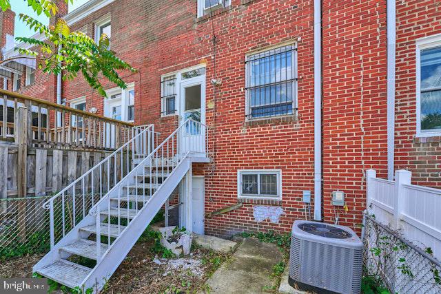 66 Allison St NE, Washington, DC 20011 - view of exterior entry featuring brick siding and central AC