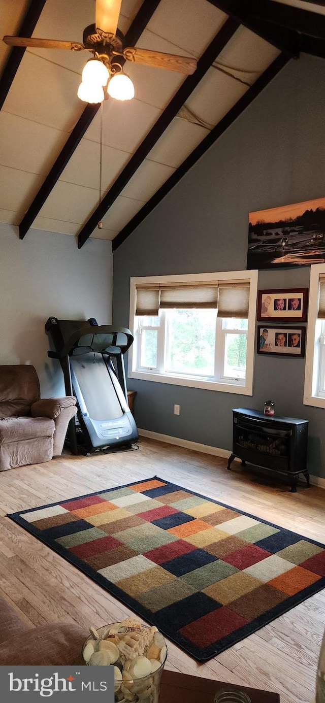 3203 N Lakeshore Dr, Browns Mills, NJ 08015 - bedroom featuring a wood stove, multiple windows, beam ceiling, wood finished floors, and baseboards