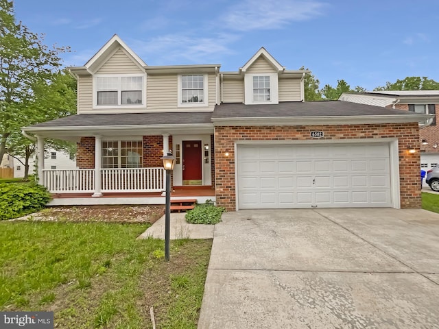 6502 Elk Ct, Waldorf, MD 20603 - view of front of home featuring covered porch, driveway, brick siding, and an attached garage