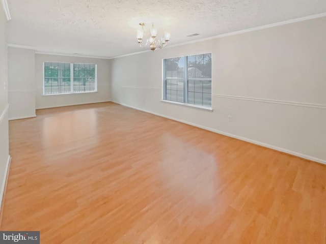 6502 Elk Ct, Waldorf, MD 20603 - empty room featuring a chandelier, wood finished floors, crown molding, baseboards, and a textured ceiling
