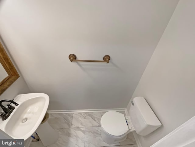 6502 Elk Ct, Waldorf, MD 20603 - bathroom featuring marble finish floors, toilet, and a sink