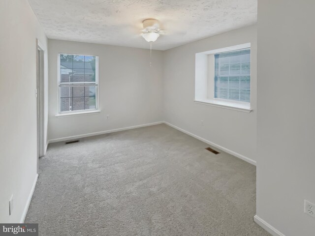 6502 Elk Ct, Waldorf, MD 20603 - spare room featuring a textured ceiling, carpet flooring, baseboards, and a ceiling fan