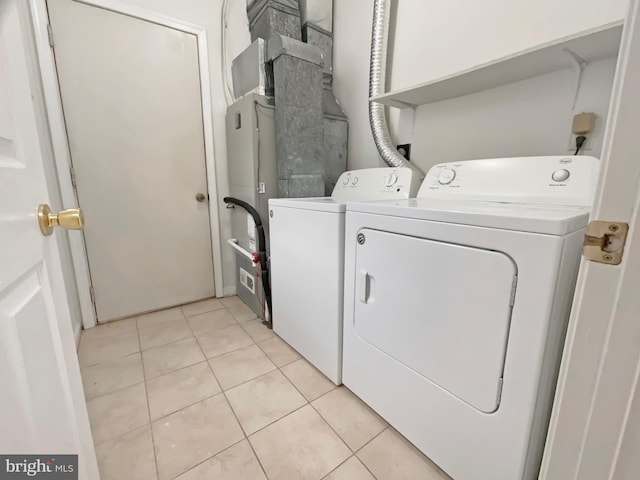 6502 Elk Ct, Waldorf, MD 20603 - laundry area with washing machine and dryer and light tile patterned floors