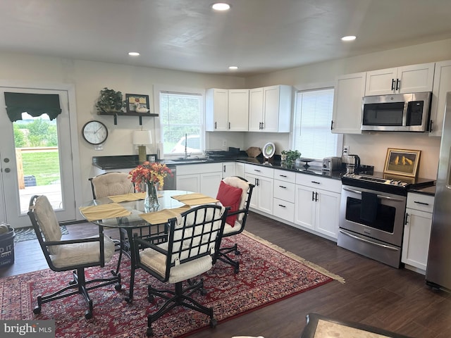 302 Glen Oak Cir, Hurlock, MD 21643 - kitchen with stainless steel appliances, healthy amount of natural light, dark wood-style flooring, dark countertops, and recessed lighting
