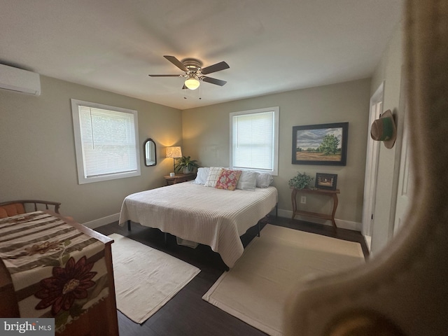 302 Glen Oak Cir, Hurlock, MD 21643 - bedroom with a wall mounted air conditioner, multiple windows, ceiling fan, and wood finished floors
