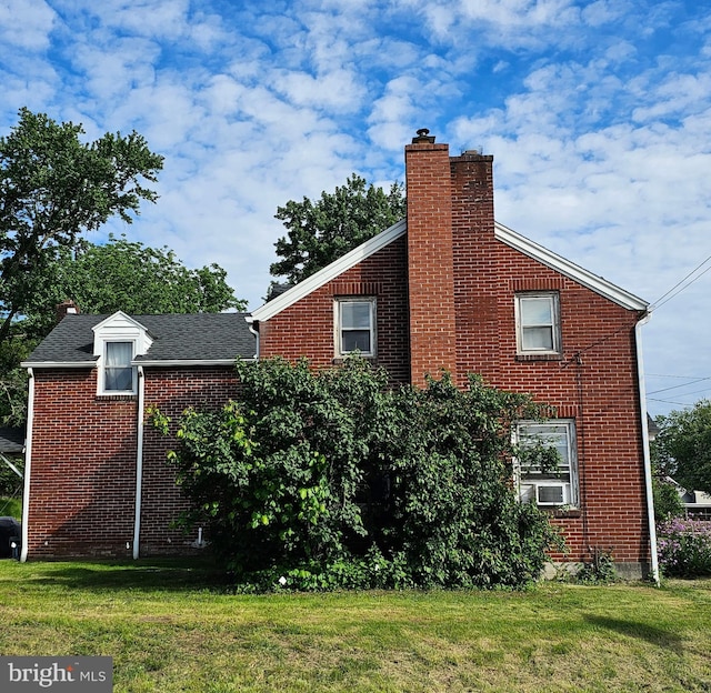 3209 E Harrisburg Pike, Middletown, PA 17057 - view of side of property with a chimney, brick siding, a yard, and cooling unit