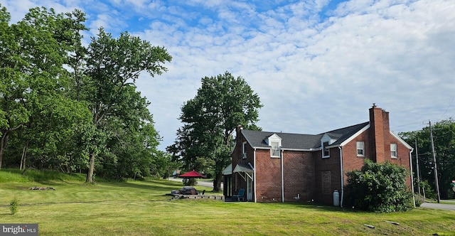 3209 E Harrisburg Pike, Middletown, PA 17057 - view of side of property with brick siding, a yard, and a chimney