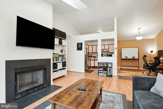 113 Timberlake Ter Unit 12, Stephens City, VA 22655 - living area featuring light wood-style floors, a skylight, lofted ceiling, baseboards, and a fireplace with flush hearth