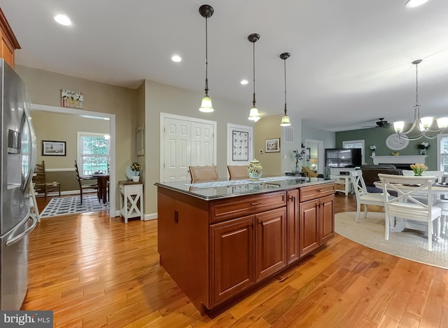 21143 Catnip Ct, Leonardtown, MD 20650 - kitchen featuring stainless steel refrigerator with ice dispenser, a chandelier, light wood finished floors, brown cabinetry, and pendant lighting