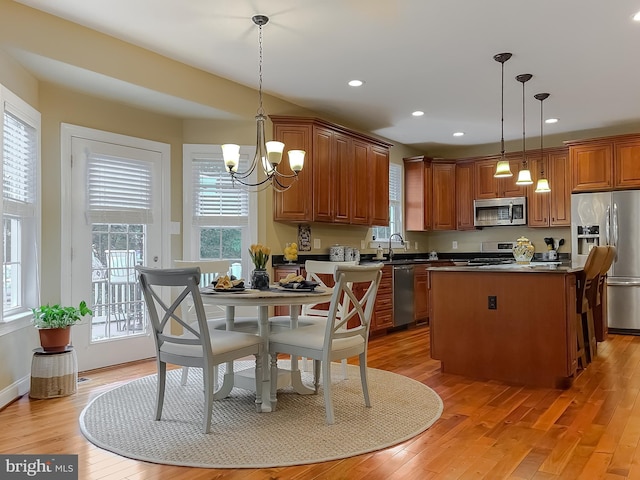 21143 Catnip Ct, Leonardtown, MD 20650 - kitchen with stainless steel appliances, a chandelier, light wood-type flooring, dark countertops, and recessed lighting