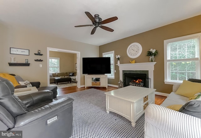 21143 Catnip Ct, Leonardtown, MD 20650 - living room featuring a ceiling fan, a warm lit fireplace, and wood finished floors