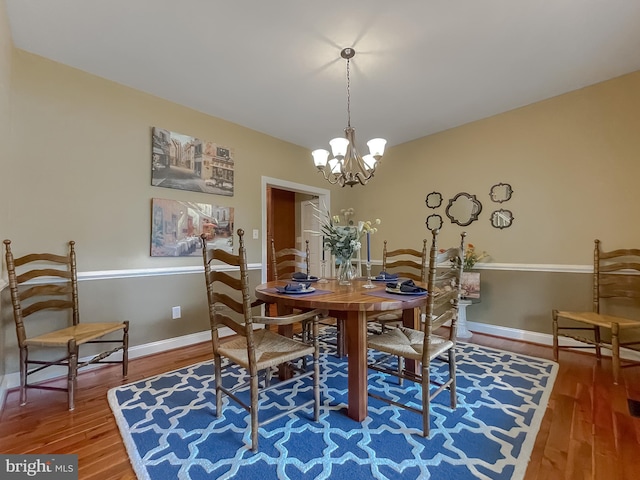 21143 Catnip Ct, Leonardtown, MD 20650 - dining area with a chandelier, wood finished floors, and baseboards