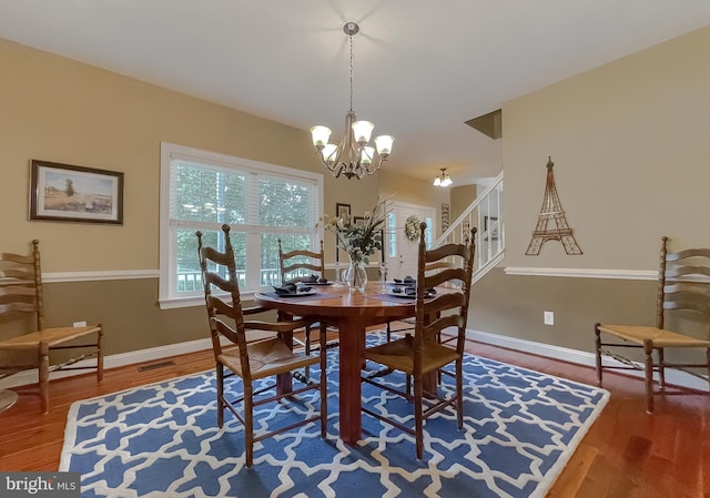 21143 Catnip Ct, Leonardtown, MD 20650 - dining space featuring wood finished floors, a chandelier, baseboards, and stairway