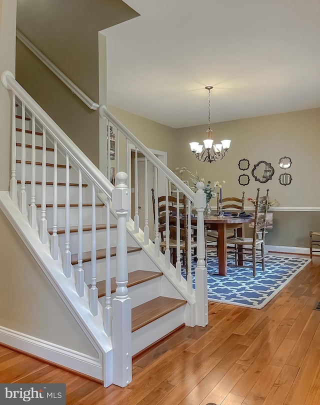 21143 Catnip Ct, Leonardtown, MD 20650 - stairs with wood finished floors, a chandelier, and baseboards